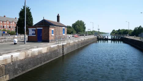 British-industrial-canal-gate-house-waterway-building-along-idyllic-footpath