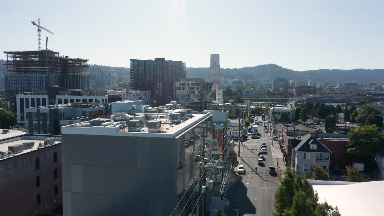 rooftops and trees in portland showing traffic on east side sunset