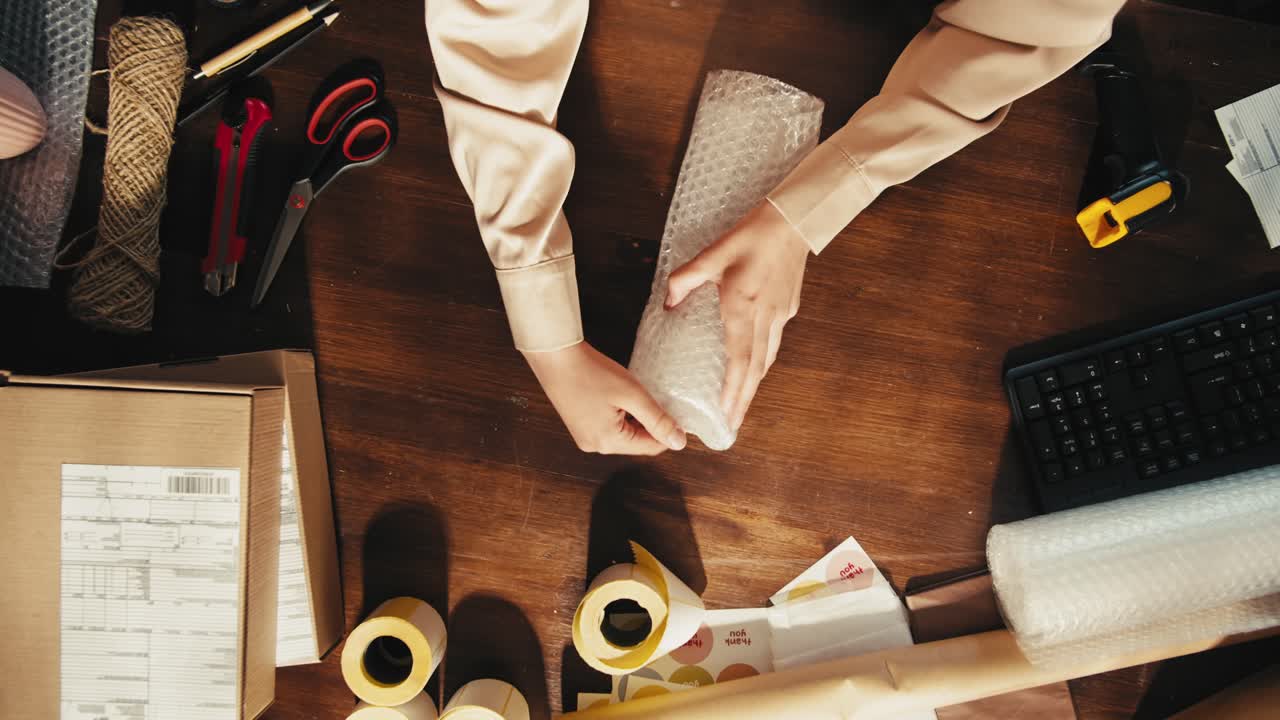 E-commerce storage shop, woman packing goods and clothes for second hand delivery market, dedicated Packaging and Shipping Workspace with Supplies and Technology for efficiency, online sales.