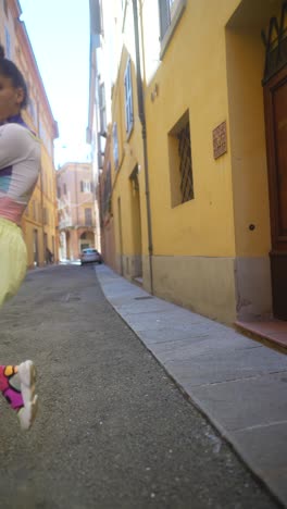 stylish woman in a colorful outfit on a city street