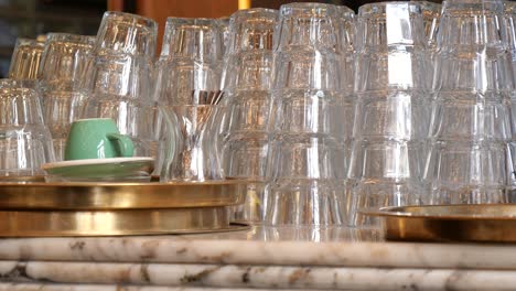 stacked glasses on a bar counter