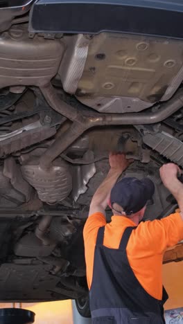 mechanic working on car's undercarriage