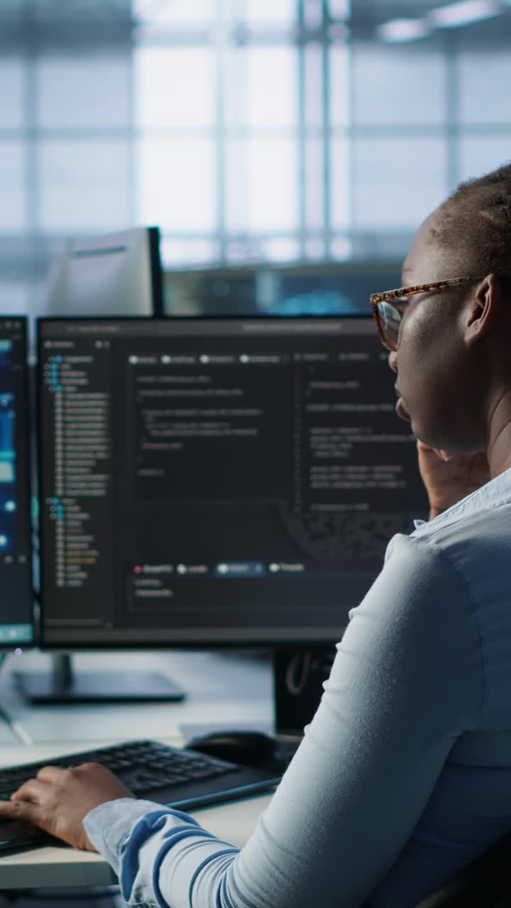 African American Woman Programmer Working on Code in Office
