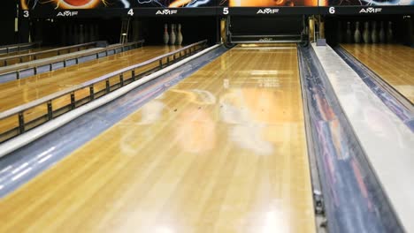 bowling lanes with bowling ball and pins