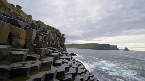 dramatic basalt columns and ocean waves at fingal's cave, scotland