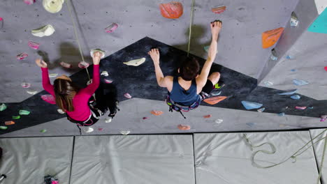 teenage boy and girl climbing indoors