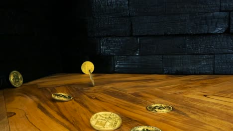 bitcoin golden and shiny cryptocurrency or crypto money coins falling on an olive wood kitchen table countertop in slow motion while a yakisugi burned or charcoal design wall panels are in the back
