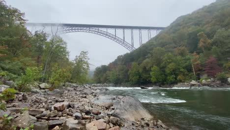 River-water-stream-running-under-The-New-River-Bridge,-low-angle-shot