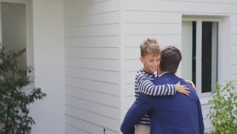 father carrying his son in the home garden 4k