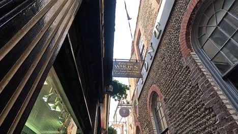 people walking through a narrow alley with shops