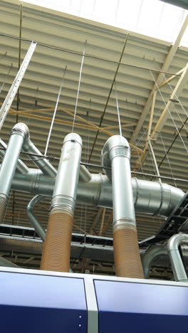 industrial zone. steel pipelines, valves, cables and walkways vertical video