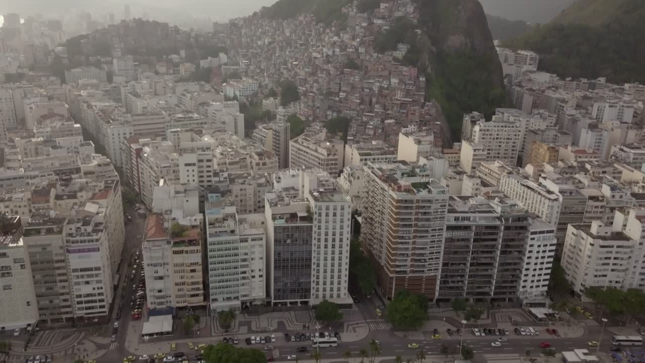 Drone shot moving backwards to reveal favelas and building in Rio De Janeiro, Brazil