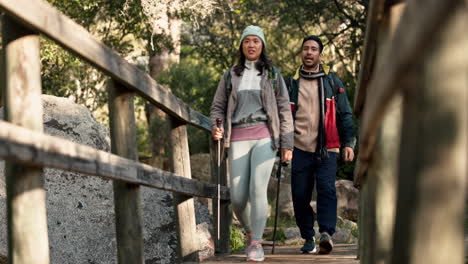 hiking, bridge and couple outdoor on a forest path