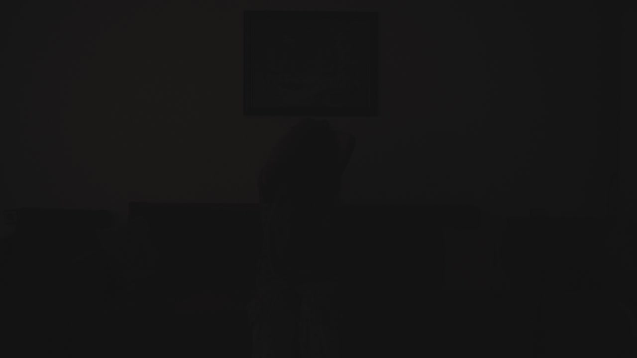 A disturbing cinematic scene of a mentally unstable woman in a dimly lit room. The eerie environment and suspenseful lighting create a tense and unsettling atmosphere