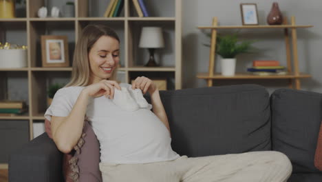 pregnant woman with baby shoes