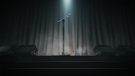 microphone stands on an empty stage in the dark