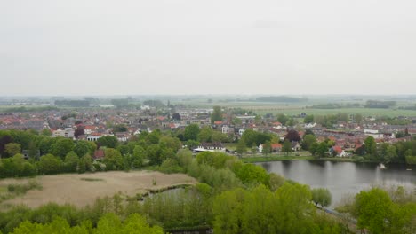 aerial approach to the city of axel in the netherlands shot on a wet cloudy day