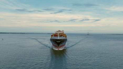 Centered-aerial-footage-of-a-sailing-cargo-container-outside-of-Charleston,-SC