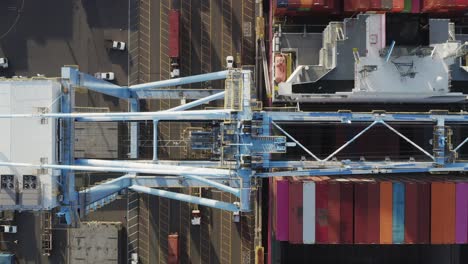 top down view of port crane and cargo containers at the husky terminal, tacoma port in washington, usa - aerial drone shot