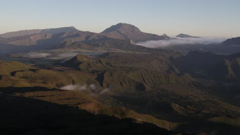 A-fly-over-the-plains-and-mountains-of-Reunion-Island-with-a-view-of-the-Piton-des-Neiges