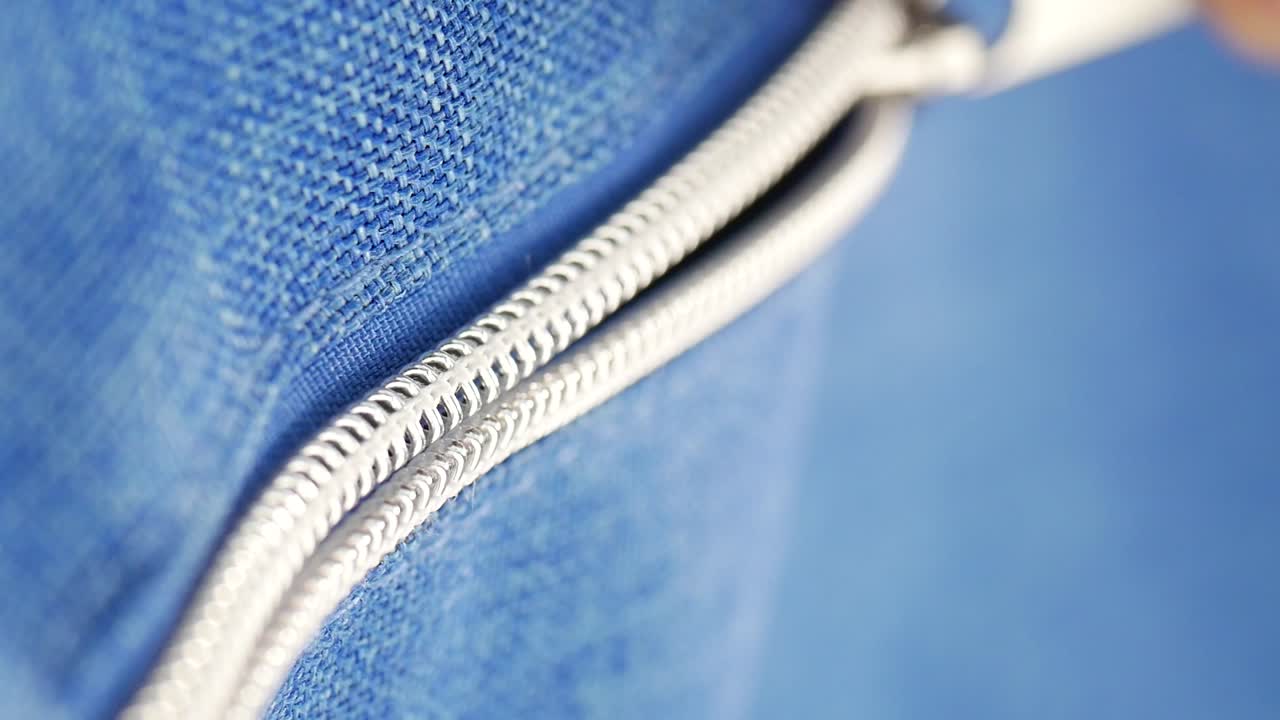 Close-up of a zipper on blue fabric
