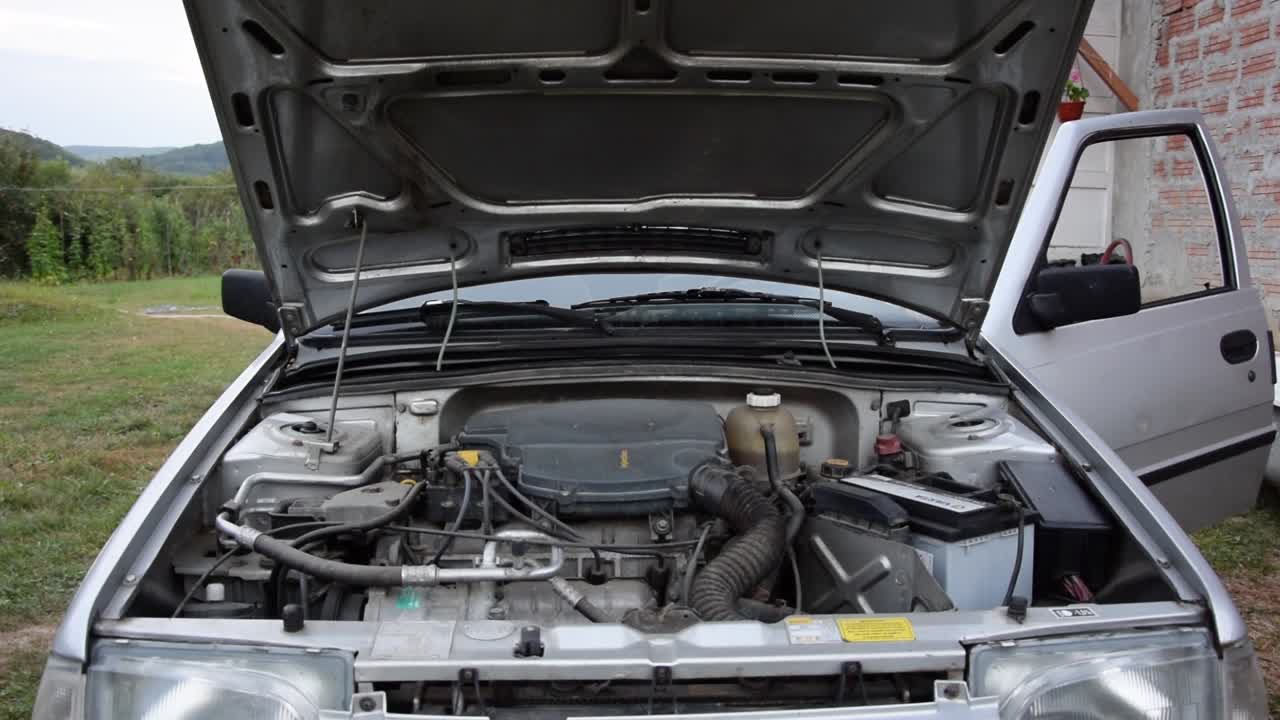An engine on an old car starts and comes to life