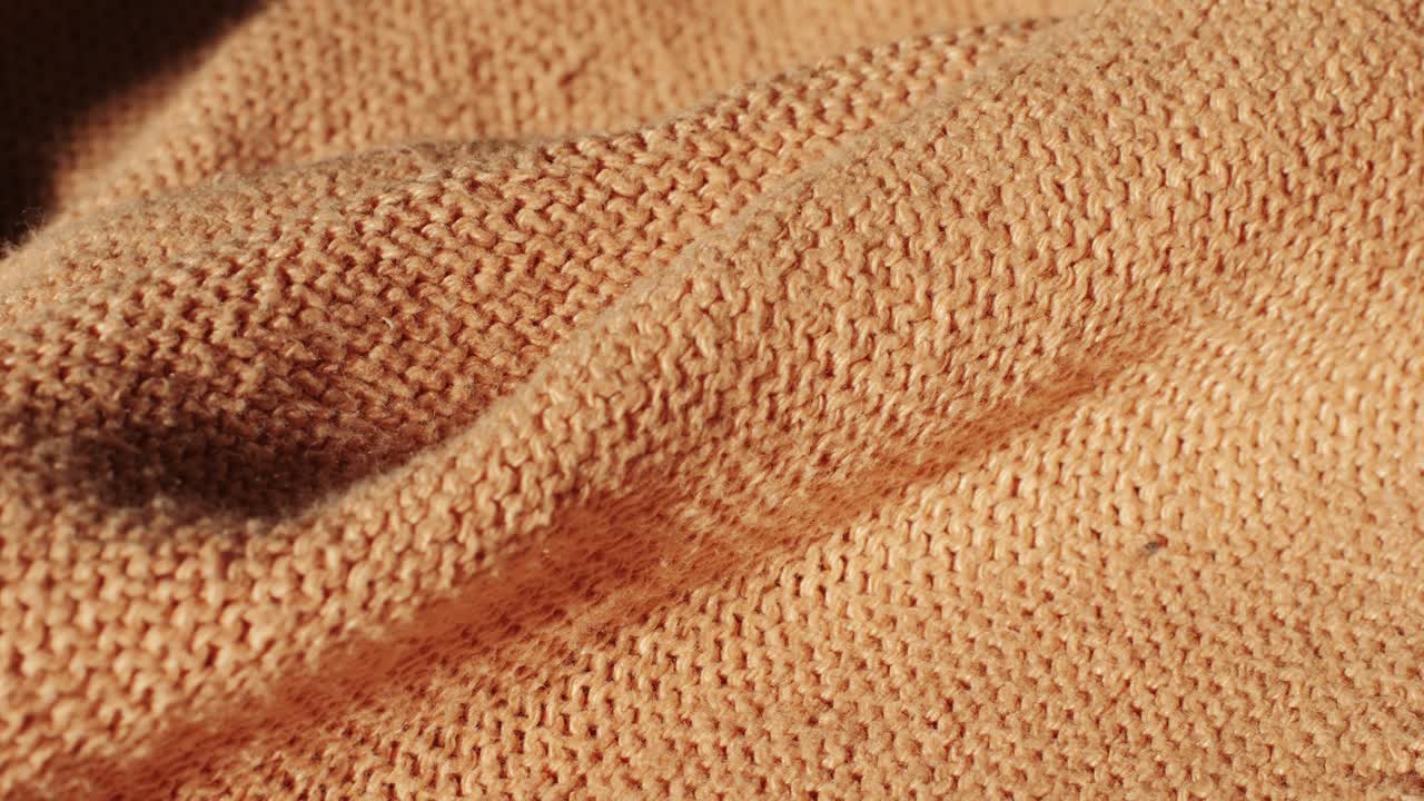 Close-up of an orange knitted fabric