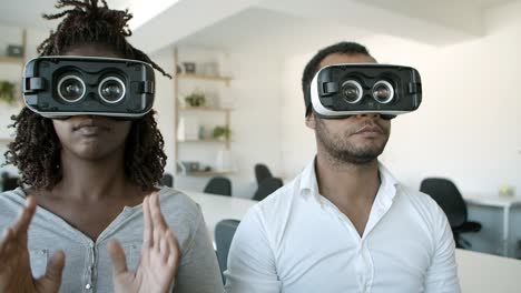 focused african american testers wearing vr glasses at office