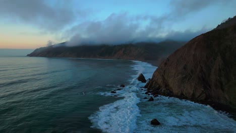 california ocean nature scene usal beach campground aerial drone bluffs cliffside mist clouds mountain rocky rugged remote coast vibrant sunset sinkyone wilderness waves crashing surf swell static
