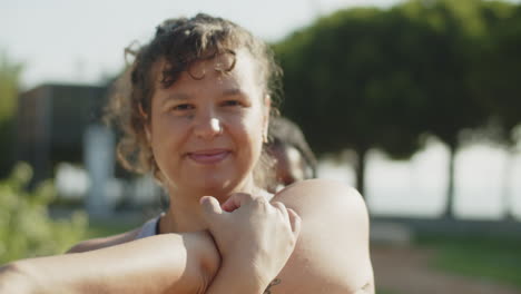 medium shot of happy woman flexing muscles before workout