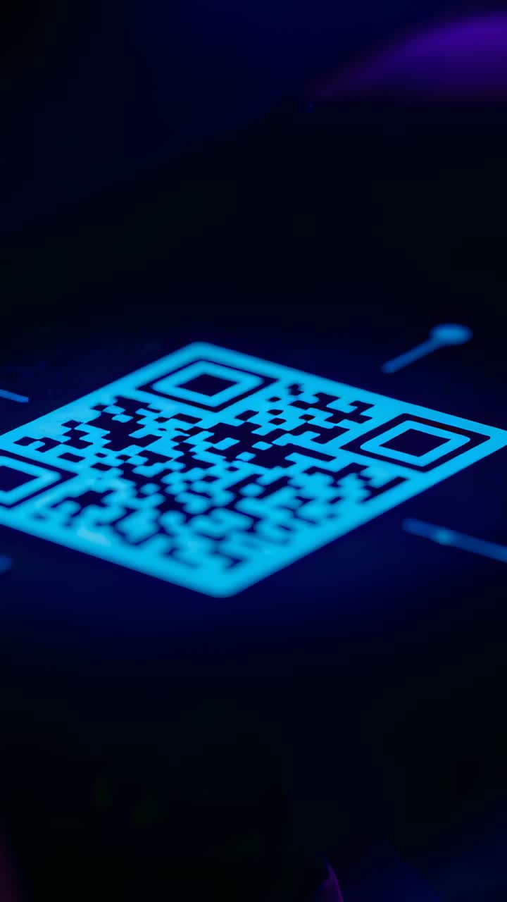 Vertical video: Pulsing cyan QR code getting scan ping on lit pad, verifying access with blue pulse