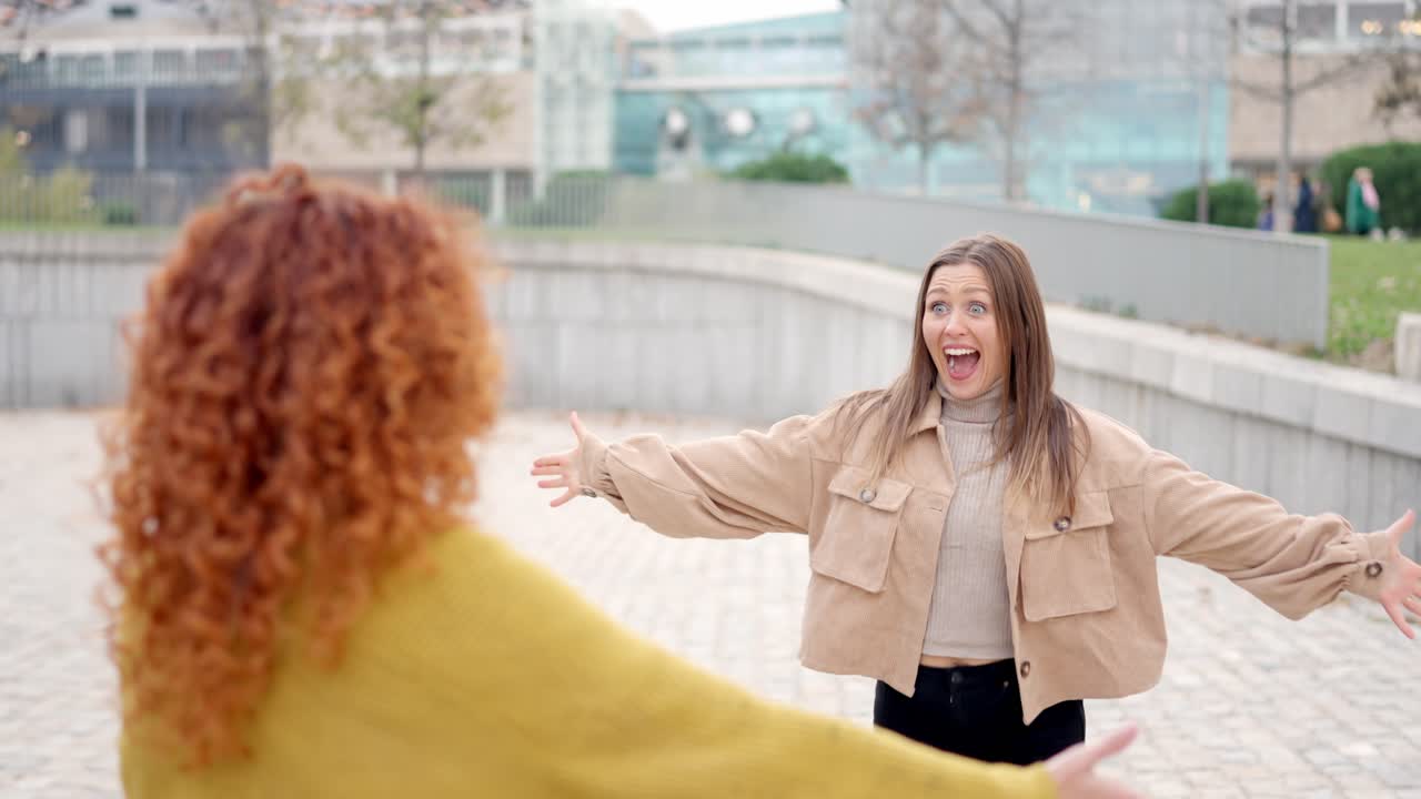 Happy meeting of two women in the street