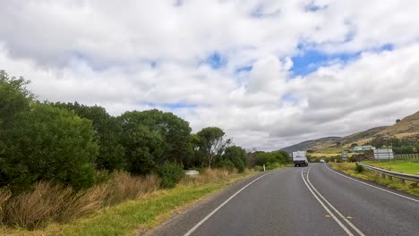 a picturesque drive on great ocean road with lush greenery, clear skies, and winding roads under natural daylight