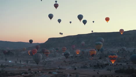 cappadocia hot air balloons glowing rising at sunrise