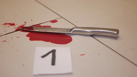 A-bloody-weapon-being-numbered-and-tagged-for-evidence-in-a-case---Close-up