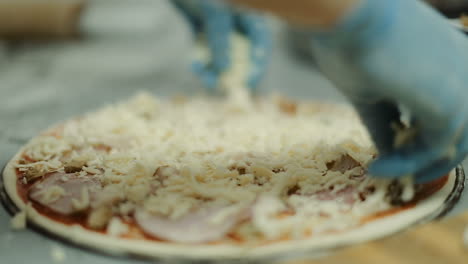 step to making pizza by chef. chef giving finishing touch to pizza in kitchen