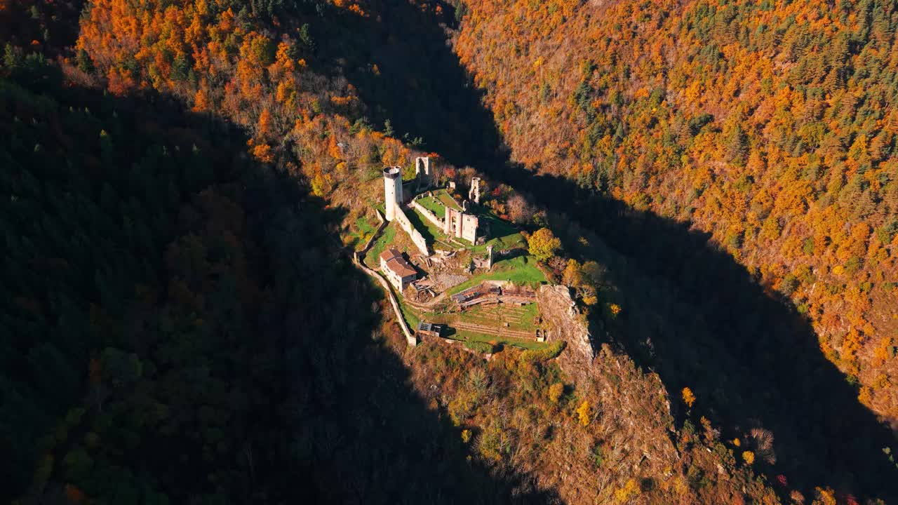 Aerial shot over the Rochebaron Castle in Bas en Basset during fall season, Haute Loire departement, Auvergne Rhone Alpes region, France
