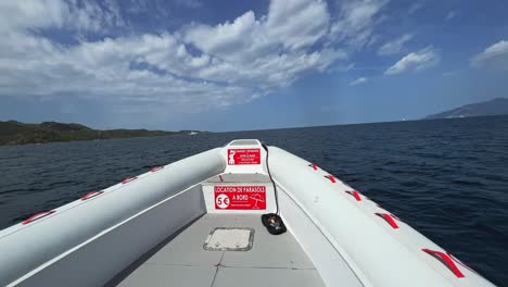 First-person-view-of-bow-of-touristic-boat-sailing-over-water-surface-of-Mediterranean-sea-in-north-Corsica,-France