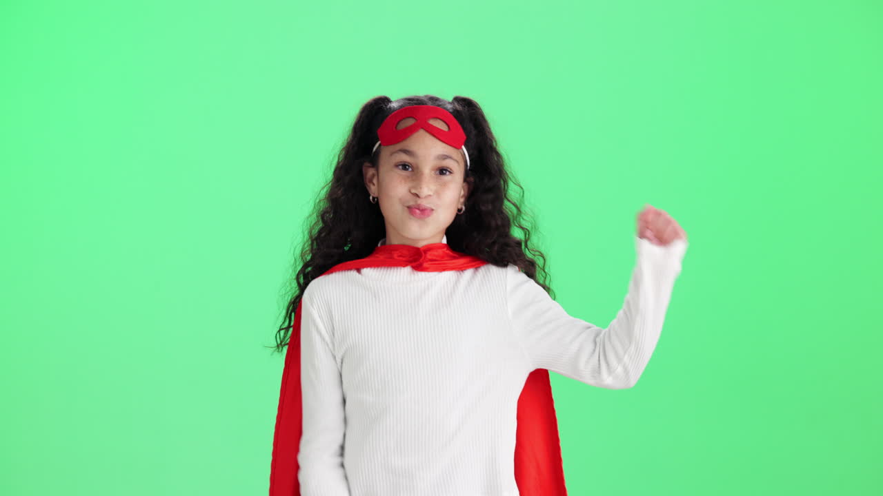 Girl dressed as superhero on green screen