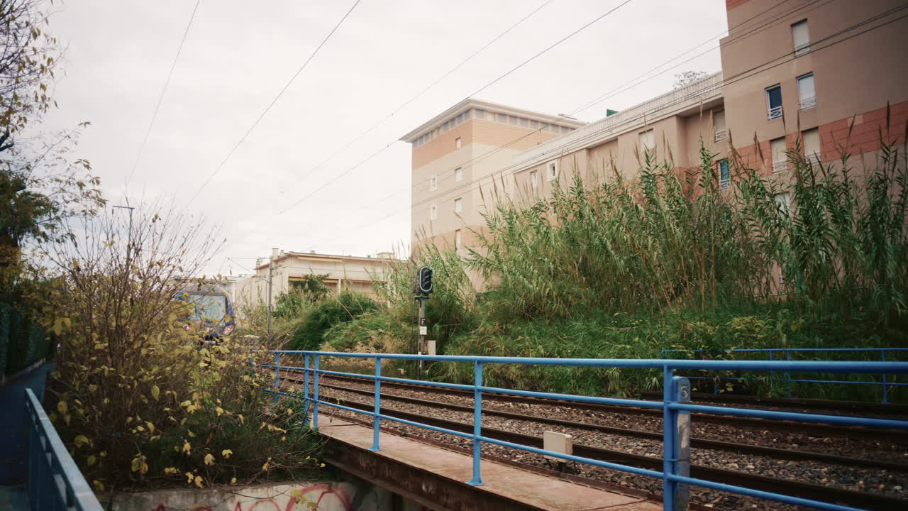 Golfe Juan, France - November 26, 2025: Regional train approaching and passing through a residential area in the South of France