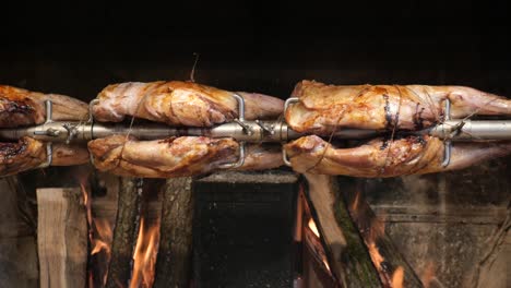 roasted lamb on a spit over fire