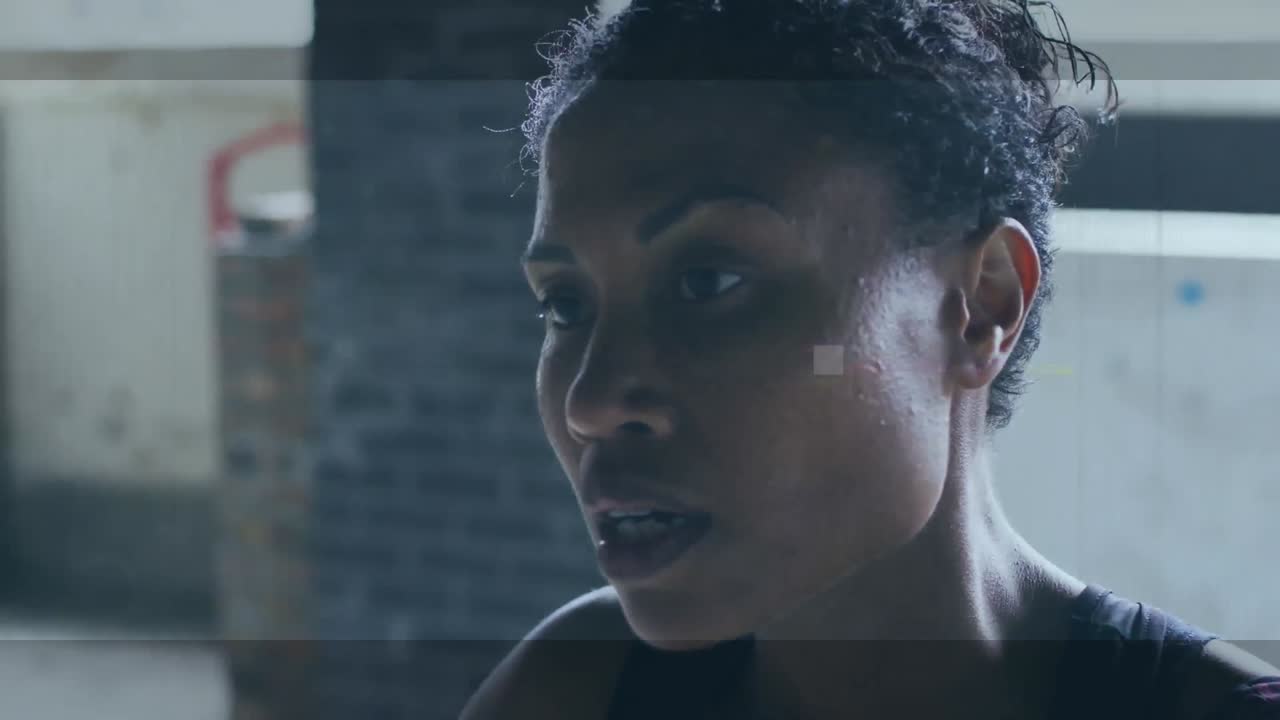 Animation of interference over african american sportswoman at gym