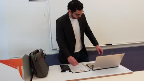 educator using laptop for university lecture prep