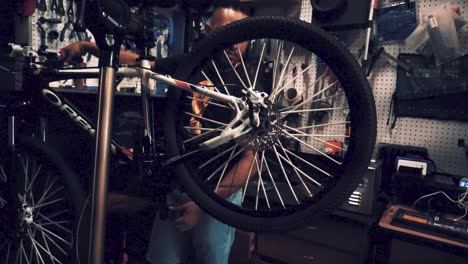 a by-cycle maker is working at his cycle garage