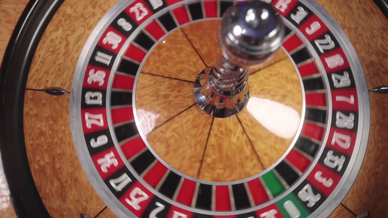 A close-up shot captures the roulette wheel spinning, as anticipation builds with every flicker of its motion.