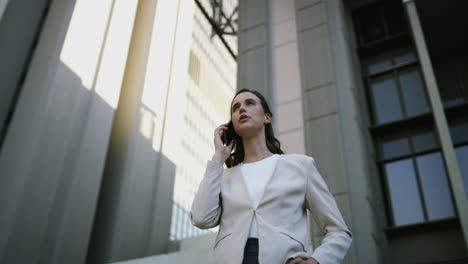 businesswoman on phone call outside office building