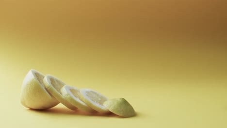 video of sliced lemon with copy space over yellow background