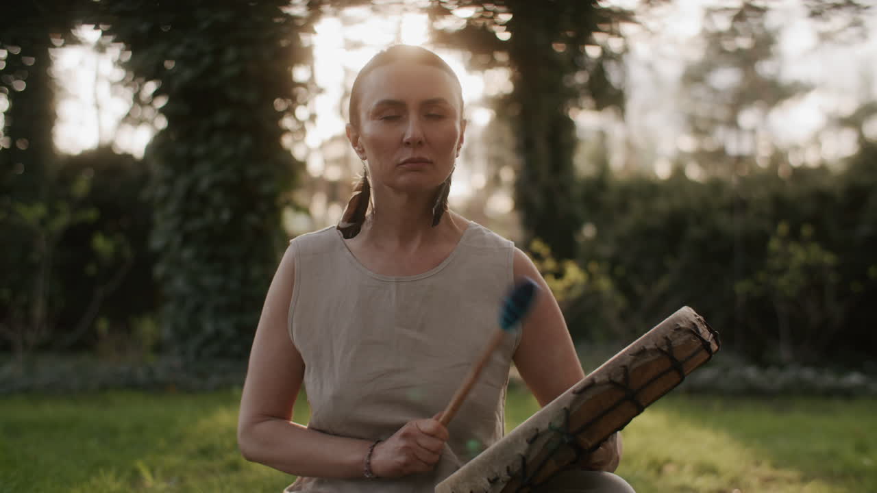 Woman Playing Drum in a Garden