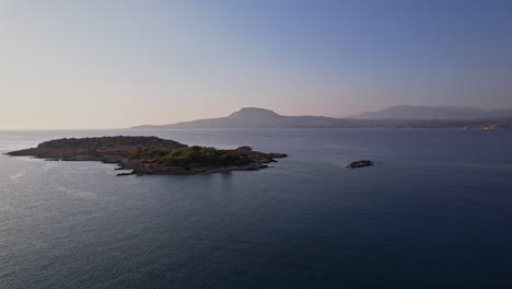 serene coastal landscape with distant hills and calm water at sunset