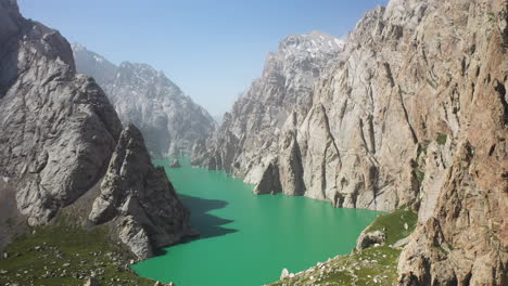 epic cinematic revealing drone shot of the large ravine surrounding the kel-suu lake in kyrgyzstan